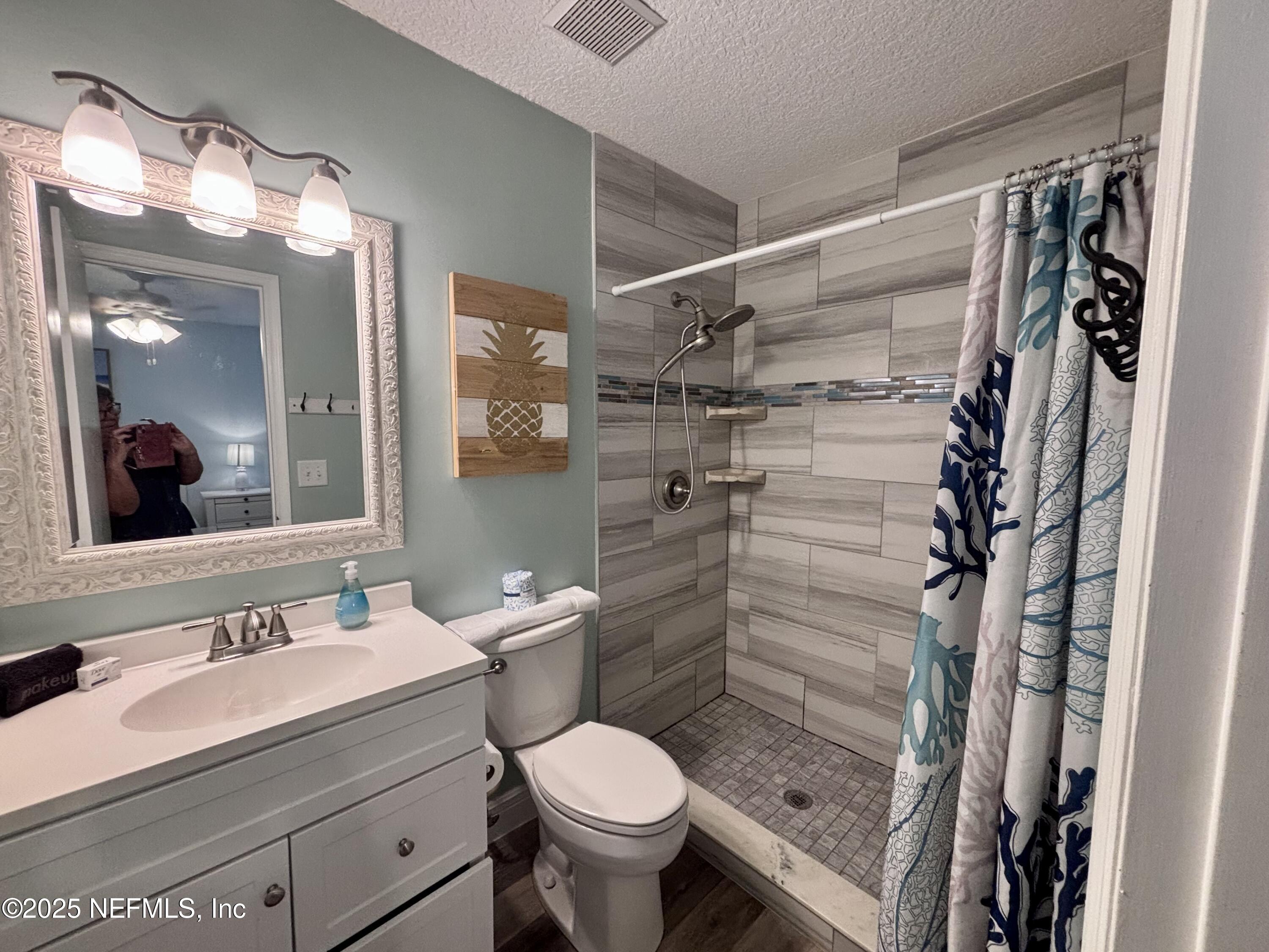 3165 1st Avenue, Unit 13 Fernandina Beach, FL 32034 - Photo 19 of 37 a bathroom with a sink toilet and shower