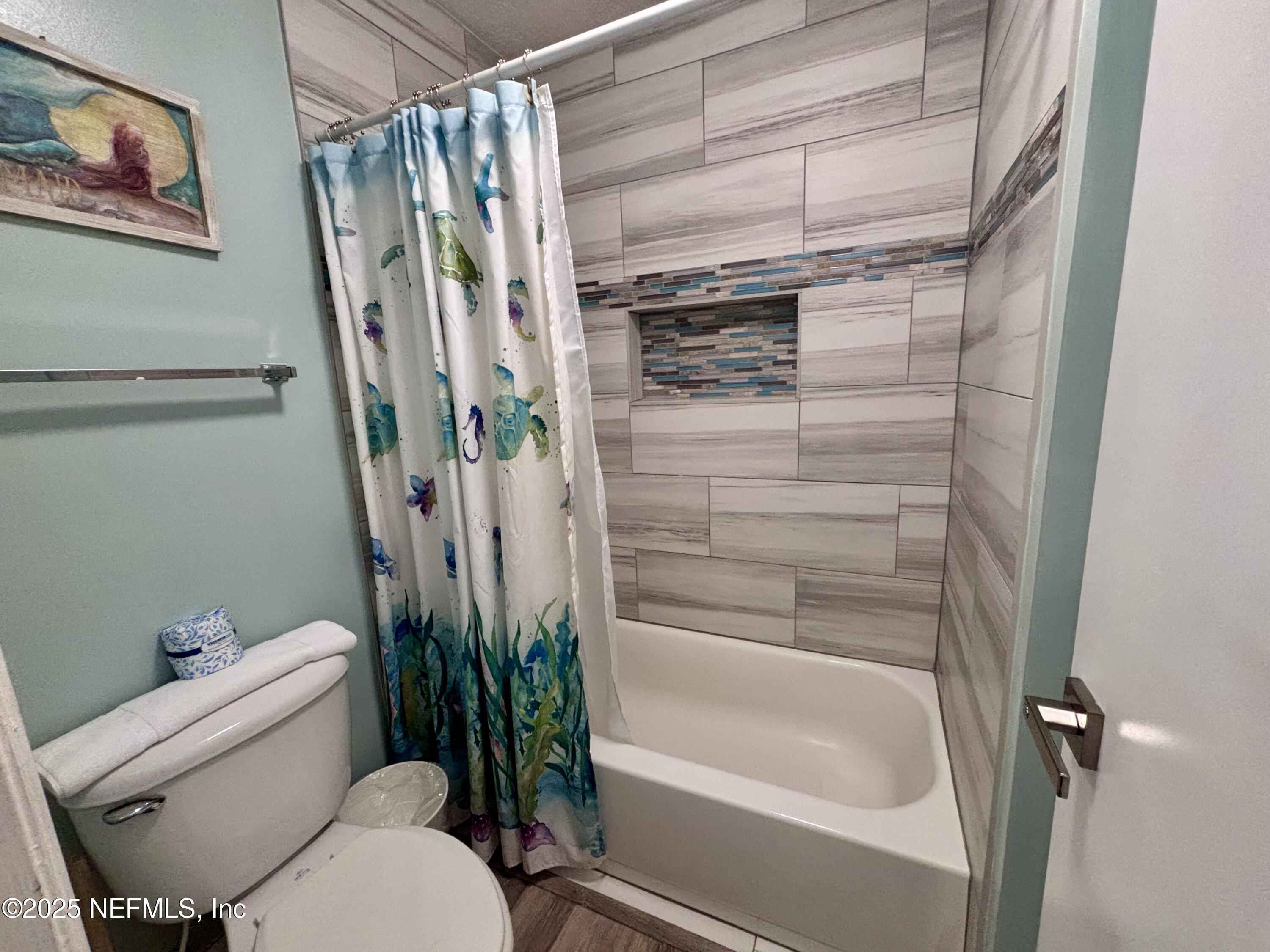 3165 1st Avenue, Unit 13 Fernandina Beach, FL 32034 - Photo 23 of 37 a bathroom with a toilet and a shower