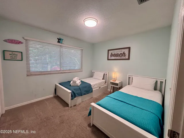 a view of room with window and a ceiling fan