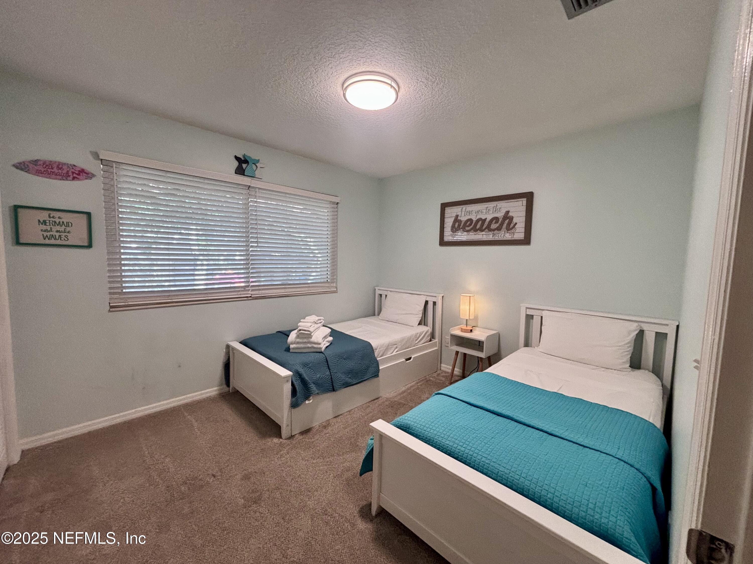 3165 1st Avenue, Unit 13 Fernandina Beach, FL 32034 - Photo 24 of 37 a bedroom with two beds and a window