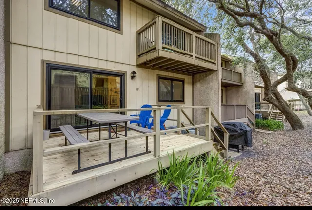 a view of backyard with deck and outdoor seating