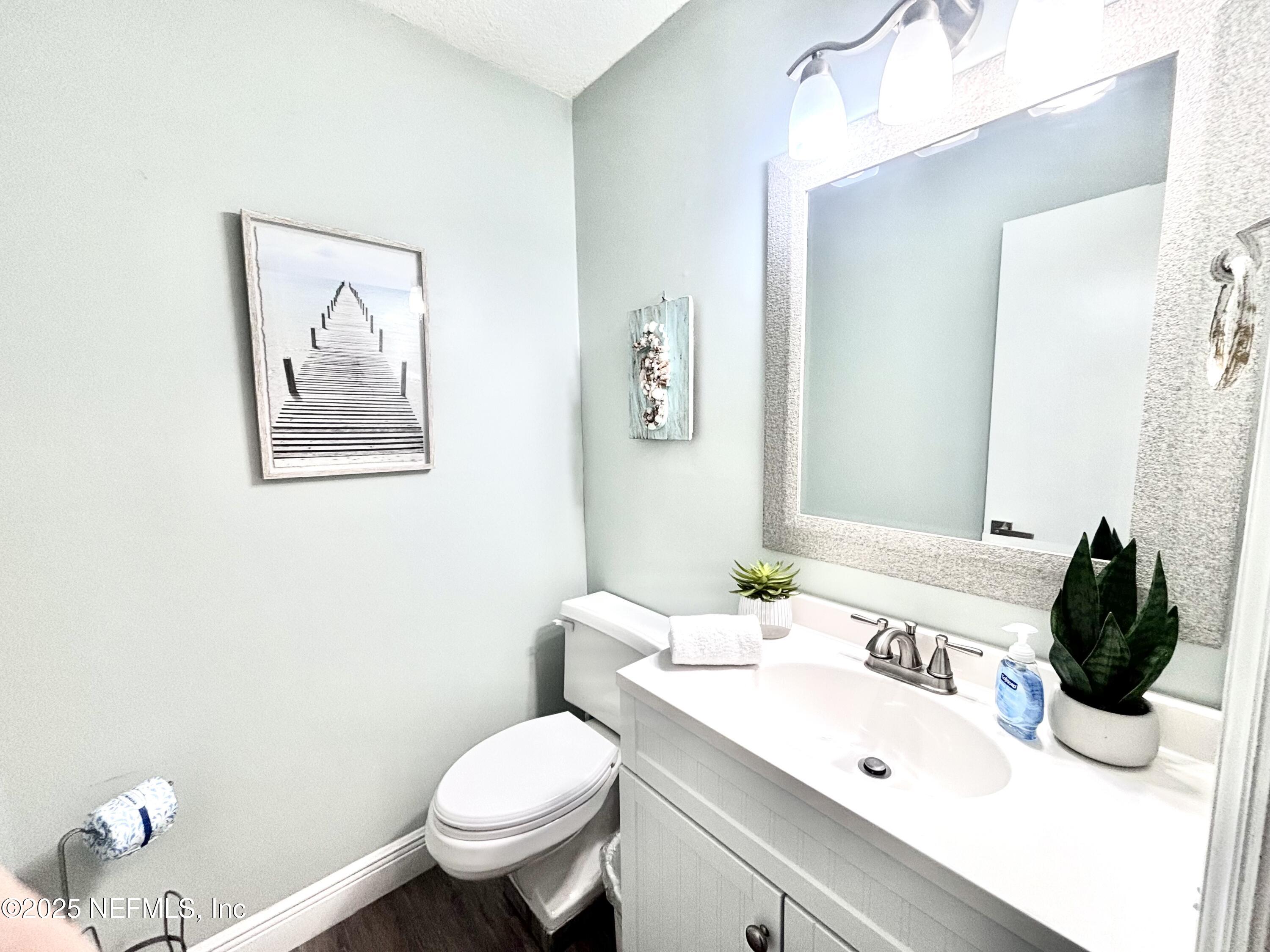 3165 1st Avenue, Unit 13 Fernandina Beach, FL 32034 - Photo 8 of 37 a bathroom with a toilet sink and mirror