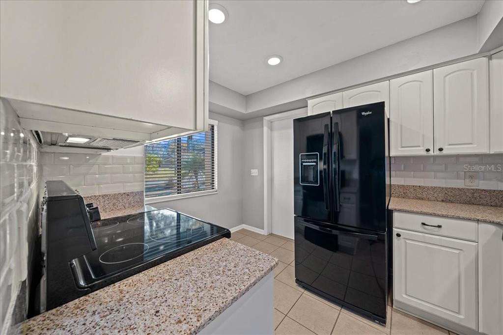 3824 Northeast 19th St Circle Ocala, FL 34470 - Photo 11 of 67 a kitchen with a refrigerator stove and cabinets