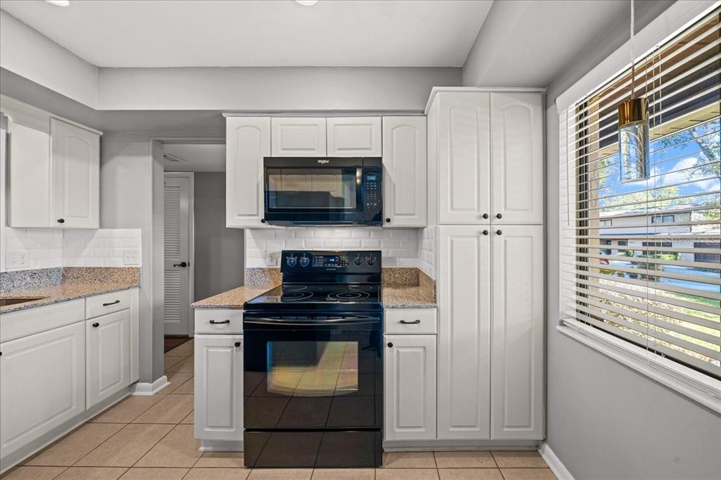 3824 Northeast 19th St Circle Ocala, FL 34470 - Photo 13 of 67 a kitchen with cabinets stainless steel appliances and wooden floor
