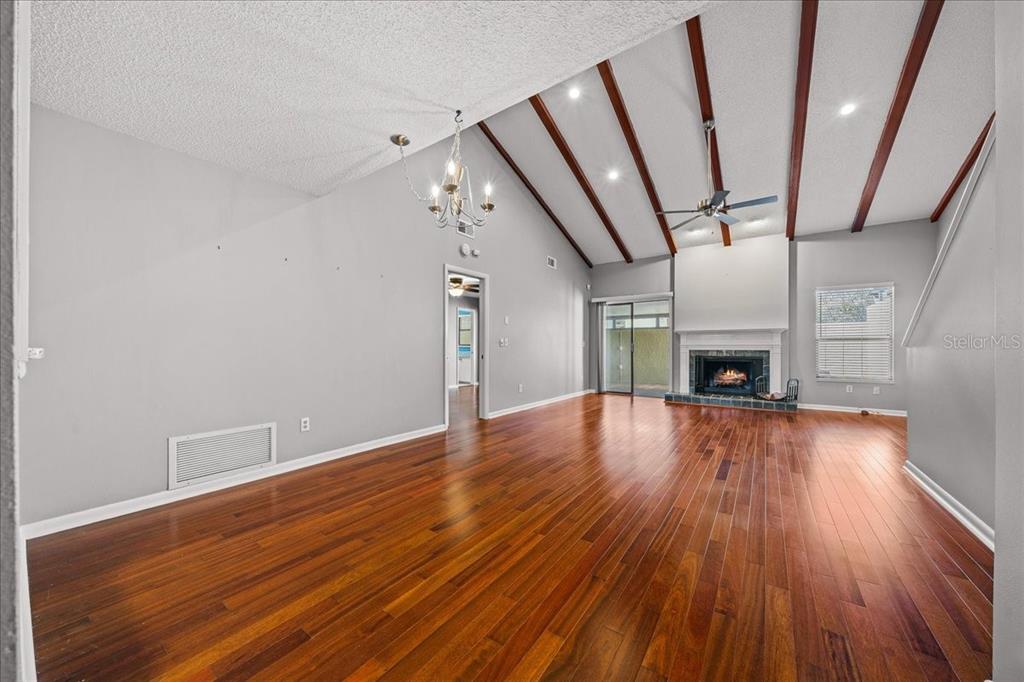 3824 Northeast 19th St Circle Ocala, FL 34470 - Photo 18 of 67 a view of empty room with wooden floor and fireplace