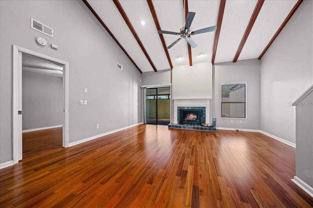 3824 Northeast 19th St Circle Ocala, FL 34470 - Photo 25 of 67 a view of empty room with wooden floor and fireplace