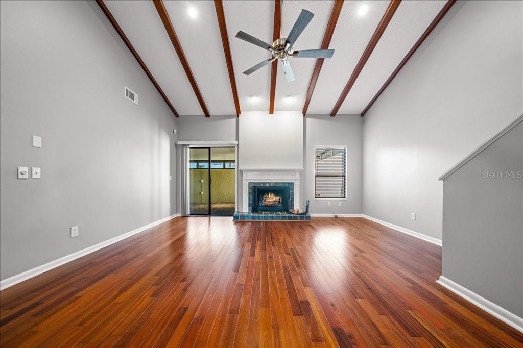 3824 Northeast 19th St Circle Ocala, FL 34470 - Photo 26 of 67 a view of an empty room with wooden floor fireplace and a window