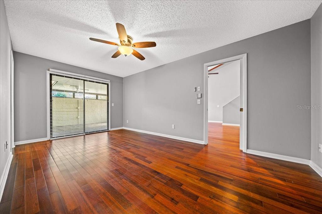 3824 Northeast 19th St Circle Ocala, FL 34470 - Photo 28 of 67 an empty room with wooden floor a ceiling fan and windows