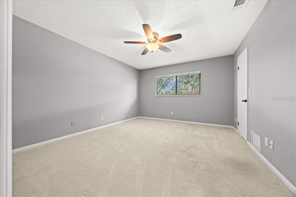 3824 Northeast 19th St Circle Ocala, FL 34470 - Photo 37 of 67 an empty room with windows and ceiling fan