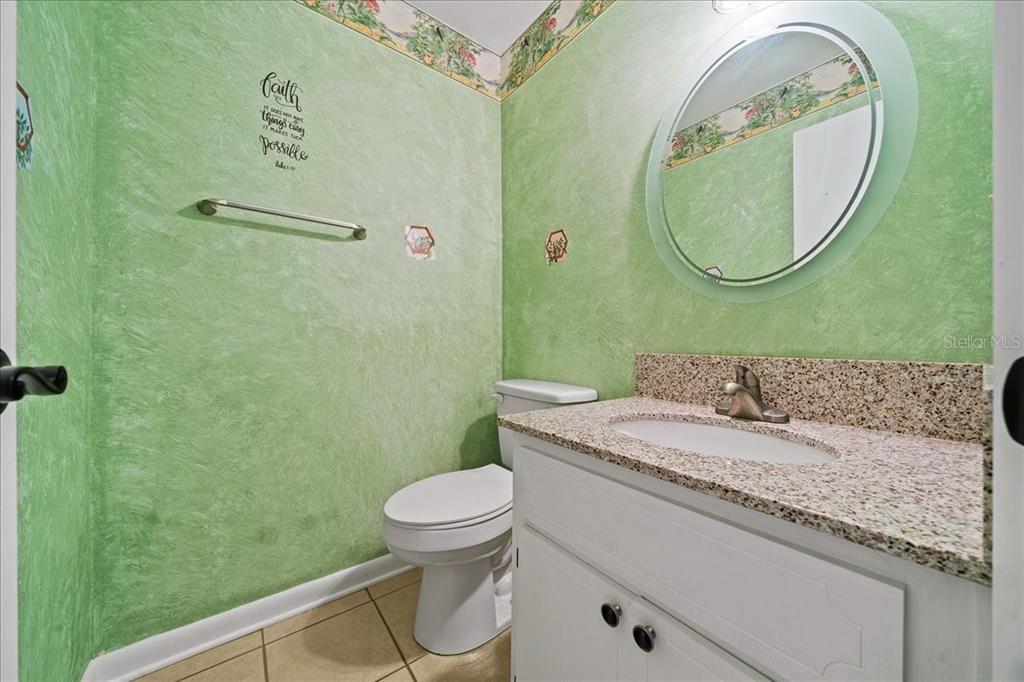 3824 Northeast 19th St Circle Ocala, FL 34470 - Photo 6 of 67 a bathroom with a granite countertop toilet sink and mirror