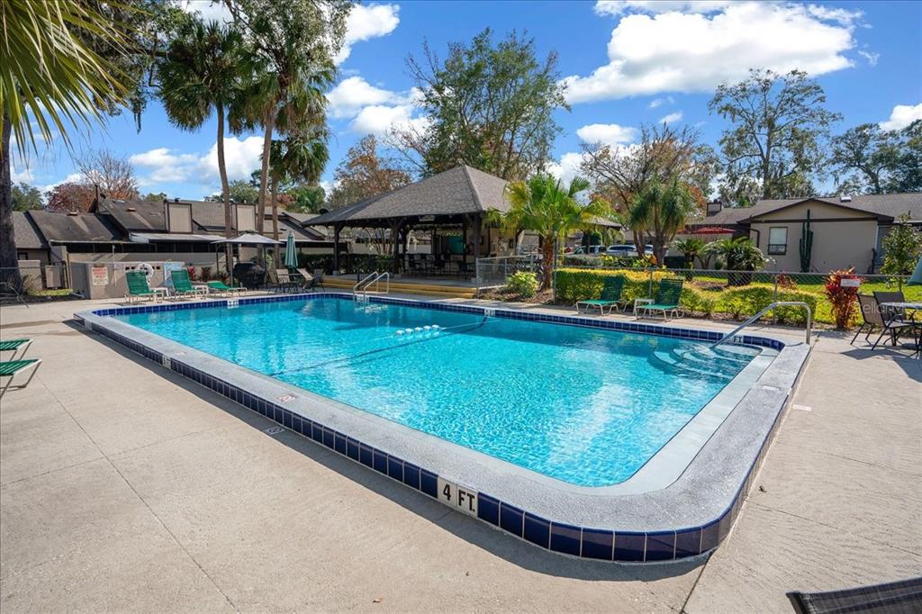 3824 Northeast 19th St Circle Ocala, FL 34470 - Photo 64 of 67 a view of swimming pool with outdoor seating and a potted plants