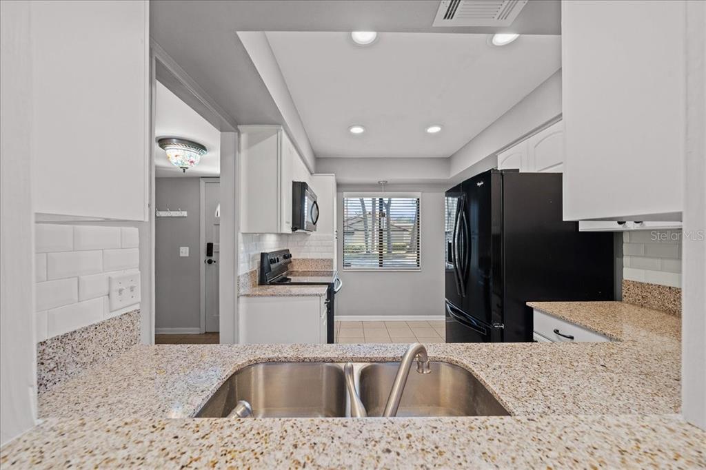 3824 Northeast 19th St Circle Ocala, FL 34470 - Photo 9 of 67 a kitchen with stainless steel appliances granite countertop a refrigerator and a sink