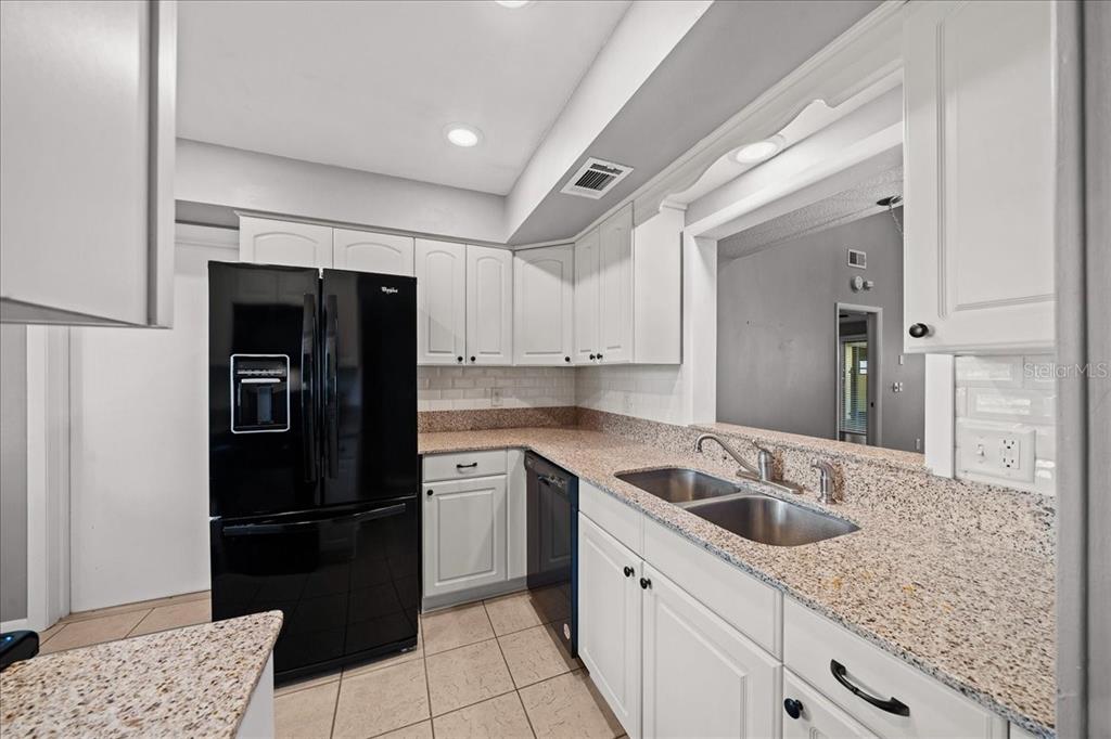 3824 Northeast 19th St Circle Ocala, FL 34470 - Photo 10 of 67 a kitchen with a sink and refrigerator