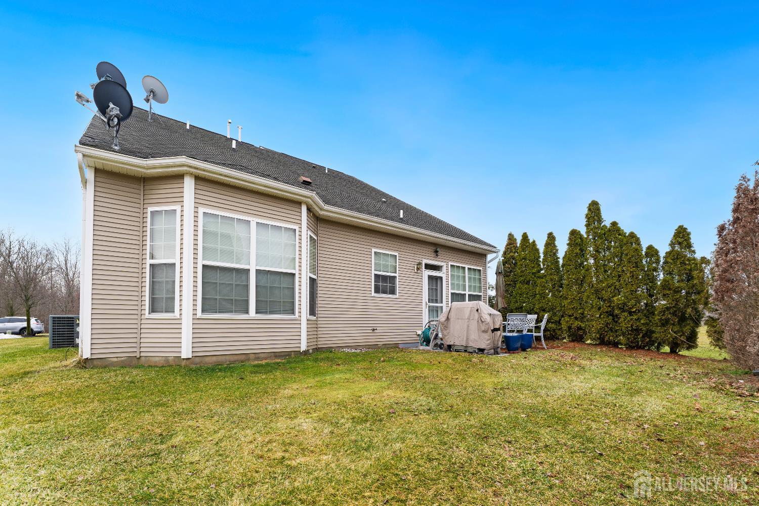 7 Spring Drive Dayton, NJ 08810 - Photo 24 of 24 a front view of house with yard and trees in the background