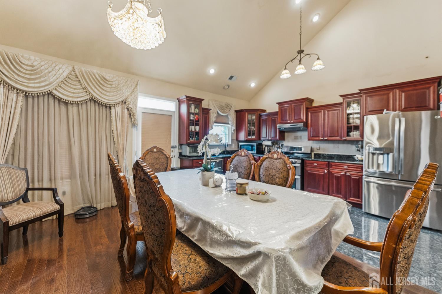 7 Spring Drive Dayton, NJ 08810 - Photo 6 of 24 a dining room with stainless steel appliances a table chairs and a chandelier