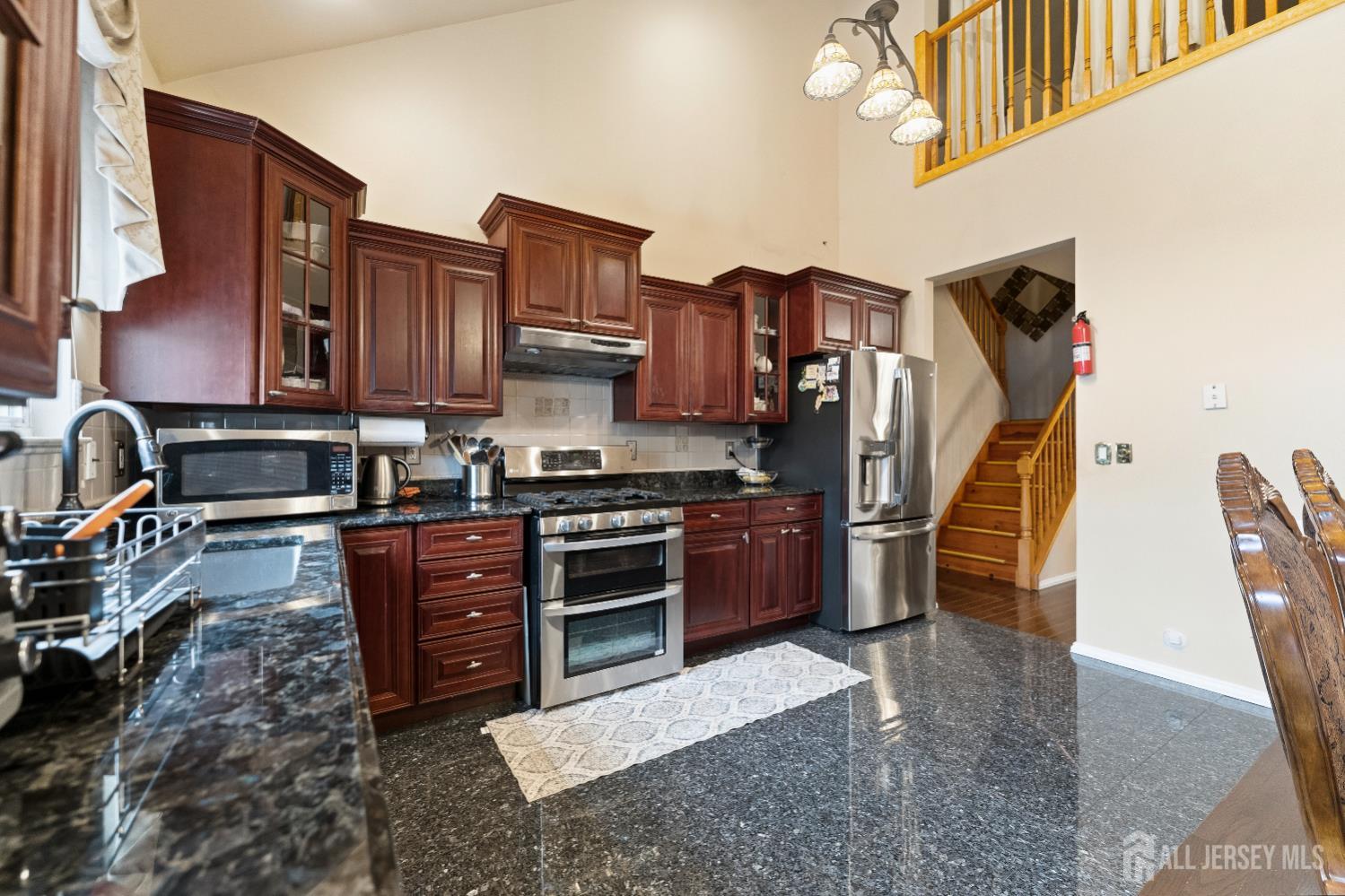 7 Spring Drive Dayton, NJ 08810 - Photo 7 of 24 a kitchen with stainless steel appliances granite countertop a stove a sink and a refrigerator