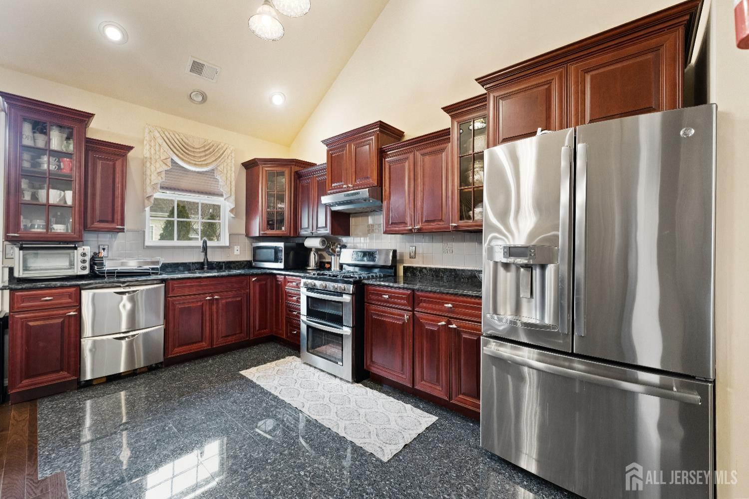 7 Spring Drive Dayton, NJ 08810 - Photo 8 of 24 a kitchen with stainless steel appliances granite countertop a refrigerator a sink dishwasher a stove and a microwave oven