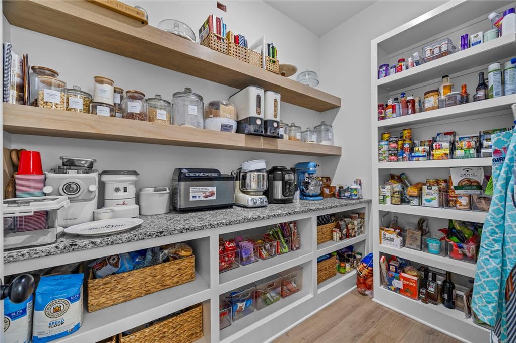 1159 Locklin Road Monroe, GA 30655 - Photo 13 of 63 a cabinet with a book shelf and a wooden floor