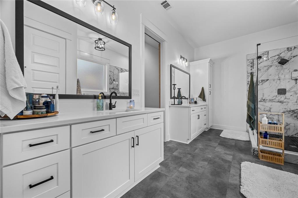 1159 Locklin Road Monroe, GA 30655 - Photo 20 of 63 a spacious bathroom with double vanity a mirrors and a shower