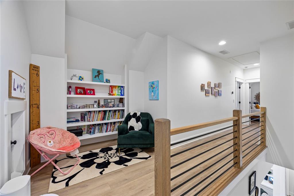 1159 Locklin Road Monroe, GA 30655 - Photo 30 of 63 a room with furniture a rug and a book shelf