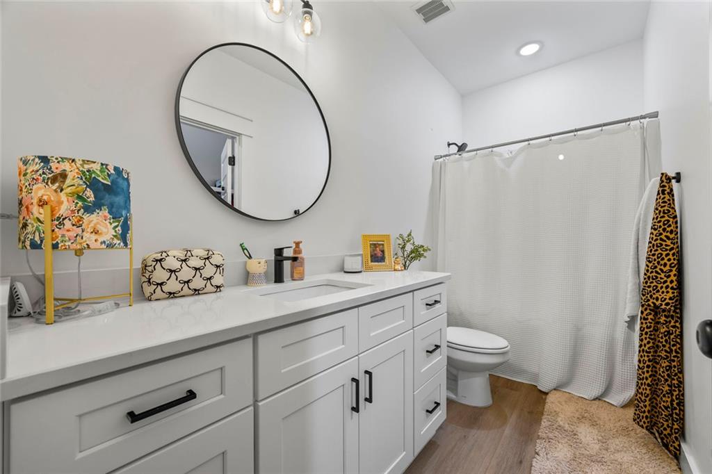 1159 Locklin Road Monroe, GA 30655 - Photo 33 of 63 a bathroom with a toilet a sink and a mirror
