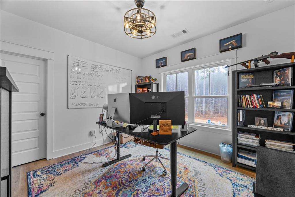 1159 Locklin Road Monroe, GA 30655 - Photo 34 of 63 a workspace with furniture and a bookshelf