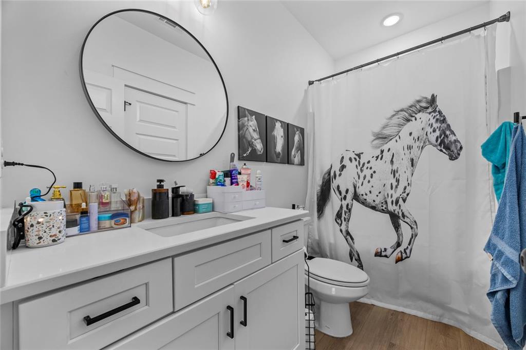 1159 Locklin Road Monroe, GA 30655 - Photo 38 of 63 a bathroom with a toilet sink vanity and mirror