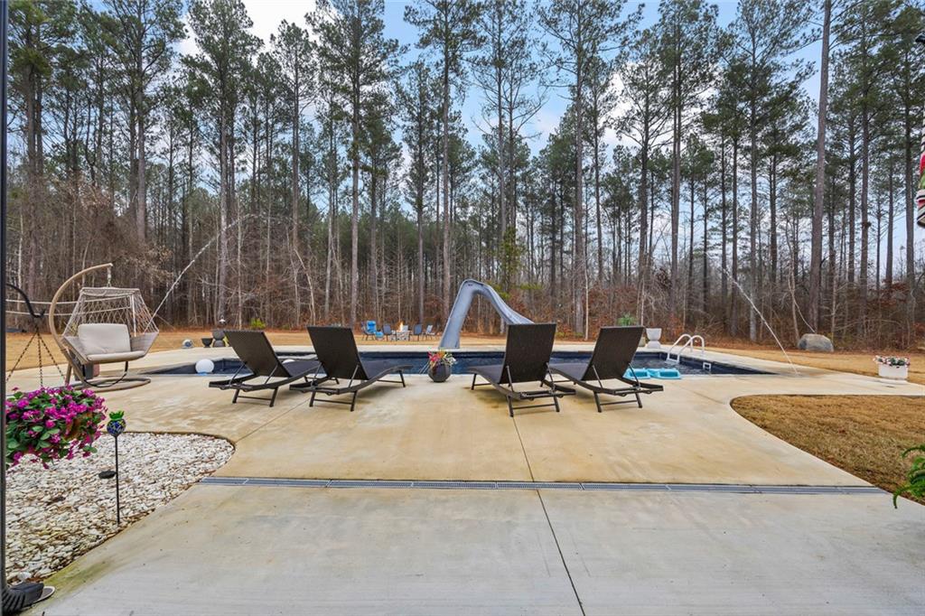 1159 Locklin Road Monroe, GA 30655 - Photo 49 of 63 a view of a patio with a table and chairs