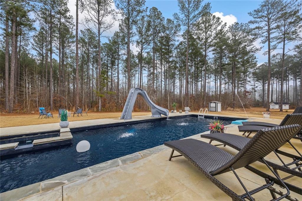 1159 Locklin Road Monroe, GA 30655 - Photo 50 of 63 a view of a swimming pool with a lounge chair