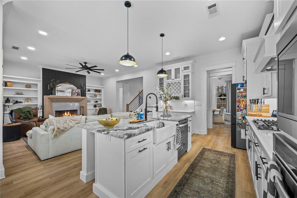 1159 Locklin Road Monroe, GA 30655 - Photo 6 of 63 a kitchen that has a lot of cabinets and wooden floor
