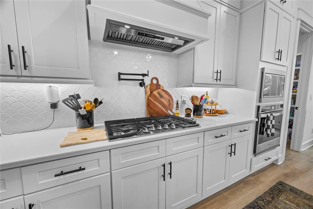 1159 Locklin Road Monroe, GA 30655 - Photo 9 of 63 a kitchen with stainless steel appliances white cabinets and a stove