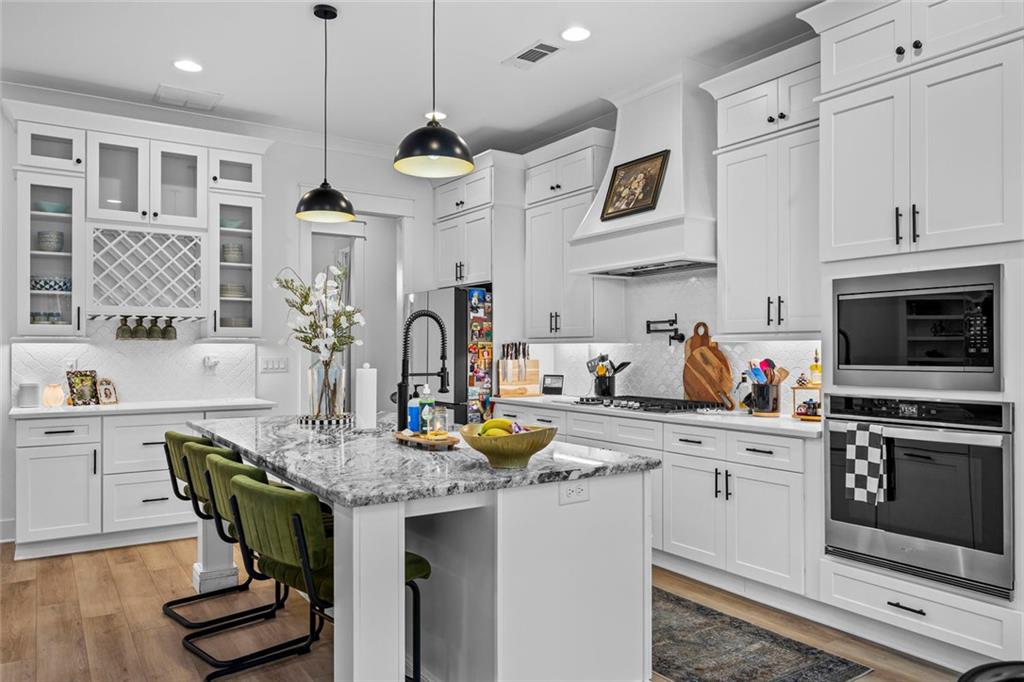 1159 Locklin Road Monroe, GA 30655 - Photo 10 of 63 a kitchen with a table chairs stove and microwave