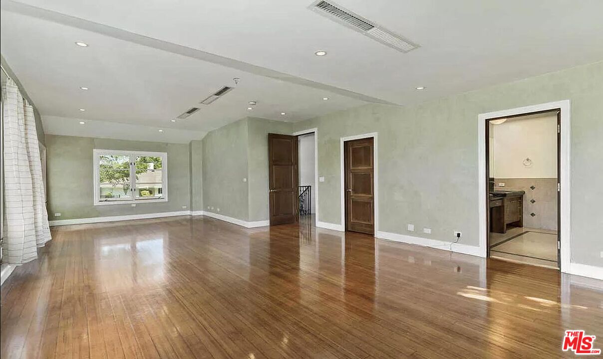 3441 White Rose Way Encino, CA 91436 - Photo 14 of 22 wooden floor in an empty room with a window
