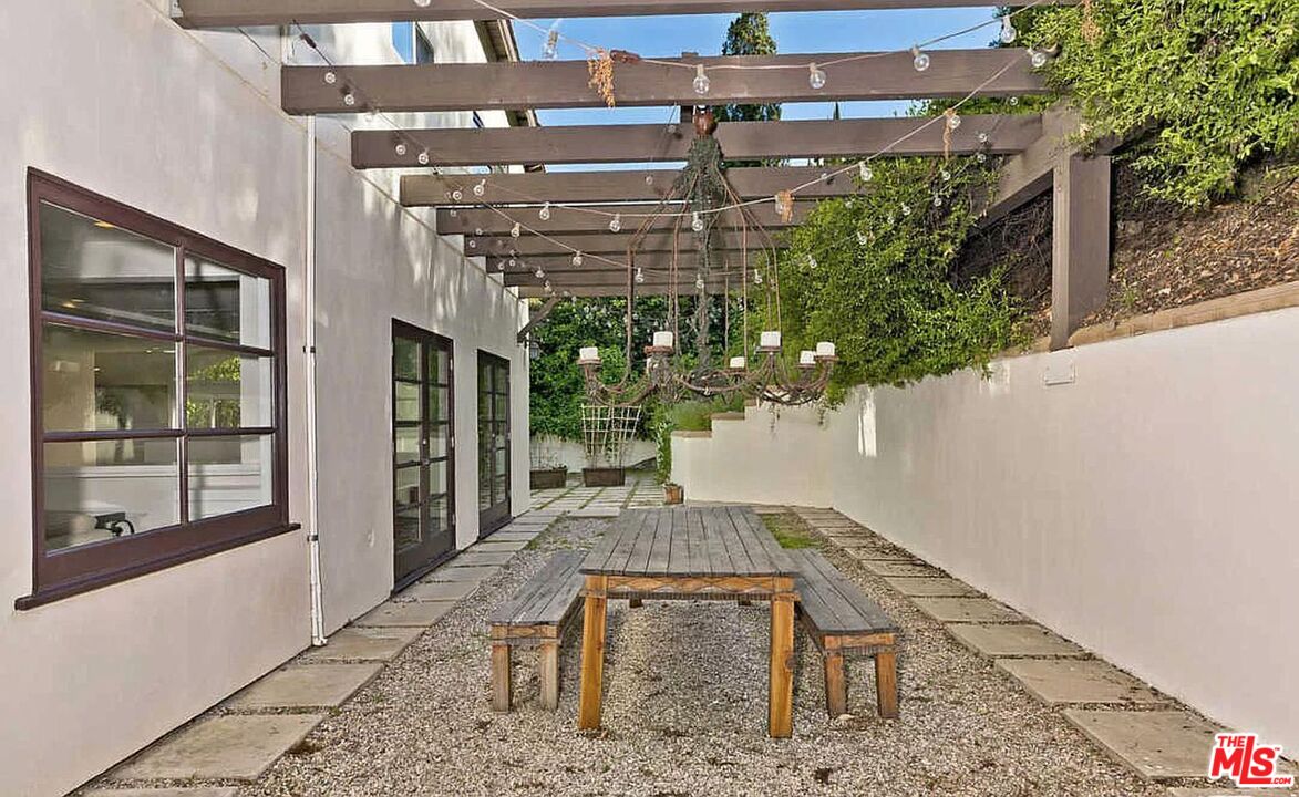 3441 White Rose Way Encino, CA 91436 - Photo 16 of 22 a bench is sitting in front of a building