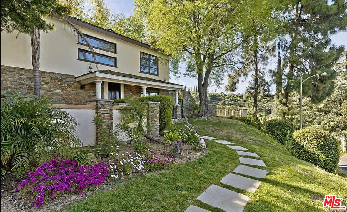 3441 White Rose Way Encino, CA 91436 - Photo 18 of 22 a front view of a house with a yard