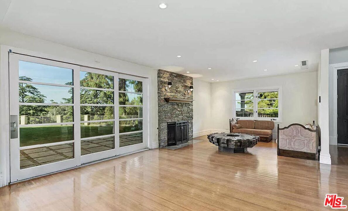 3441 White Rose Way Encino, CA 91436 - Photo 6 of 22 a living room with furniture window and a fireplace