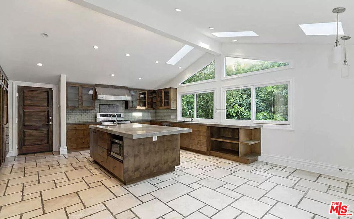 3441 White Rose Way Encino, CA 91436 - Photo 8 of 22 a kitchen with stainless steel appliances granite countertop a stove a sink and a refrigerator
