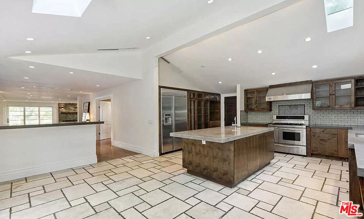 3441 White Rose Way Encino, CA 91436 - Photo 9 of 22 a kitchen with stainless steel appliances a stove a sink a refrigerator and a cabinets