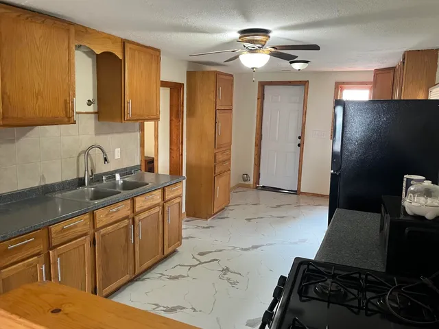 a kitchen with stainless steel appliances a sink stove and refrigerator