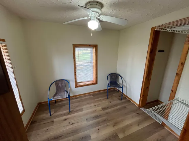 a view of a workspace with furniture and a window