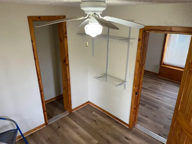 a view of a hallway with wooden floor