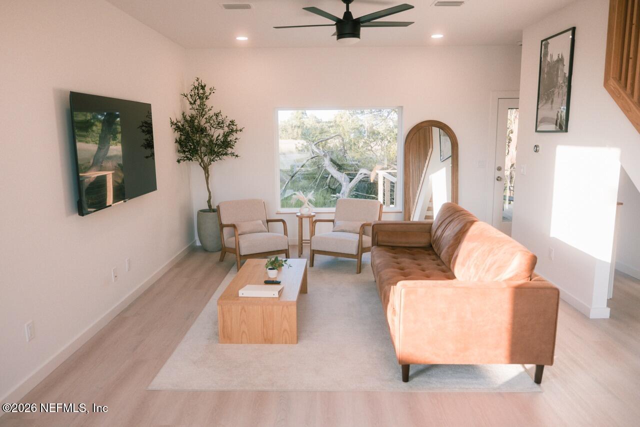 a living room with furniture and a large window