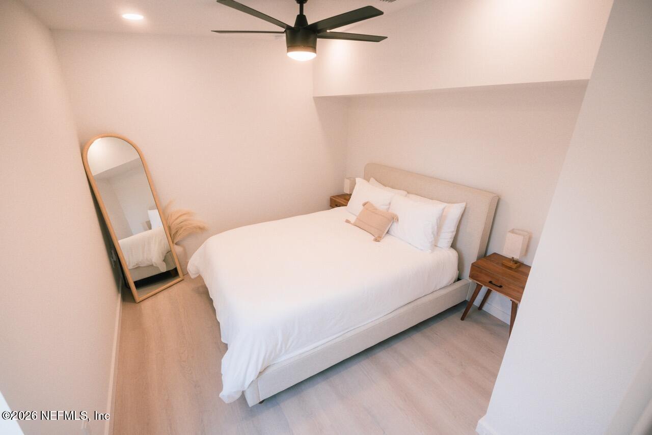 3318 Lewis Speedway St. Augustine, FL 32084 - Photo 16 of 23 a bedroom with a bed and a chair