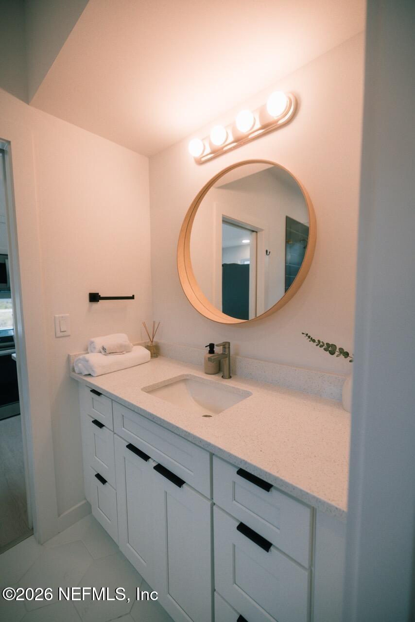 3318 Lewis Speedway St. Augustine, FL 32084 - Photo 17 of 23 a bathroom with a sink and a mirror