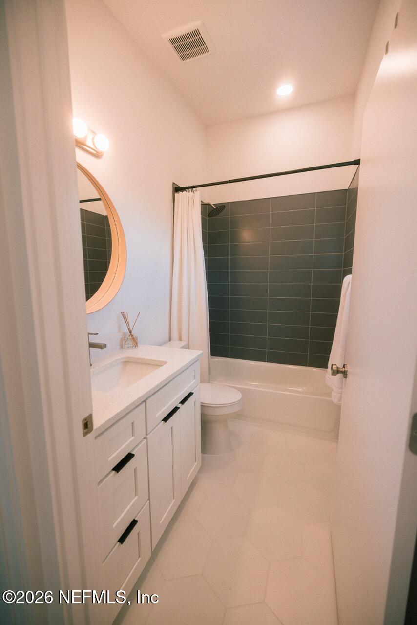 3318 Lewis Speedway St. Augustine, FL 32084 - Photo 18 of 23 a bathroom with a granite countertop sink toilet and shower