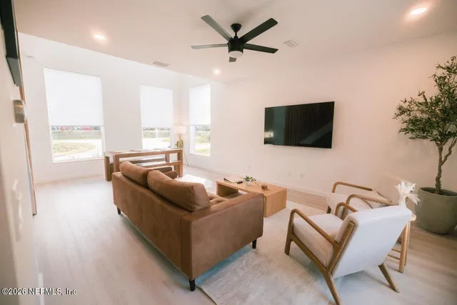 a living room with furniture and a flat screen tv