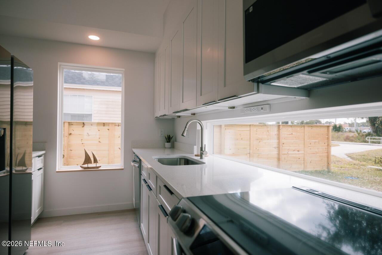 3318 Lewis Speedway St. Augustine, FL 32084 - Photo 5 of 23 a kitchen with a sink appliances and cabinets
