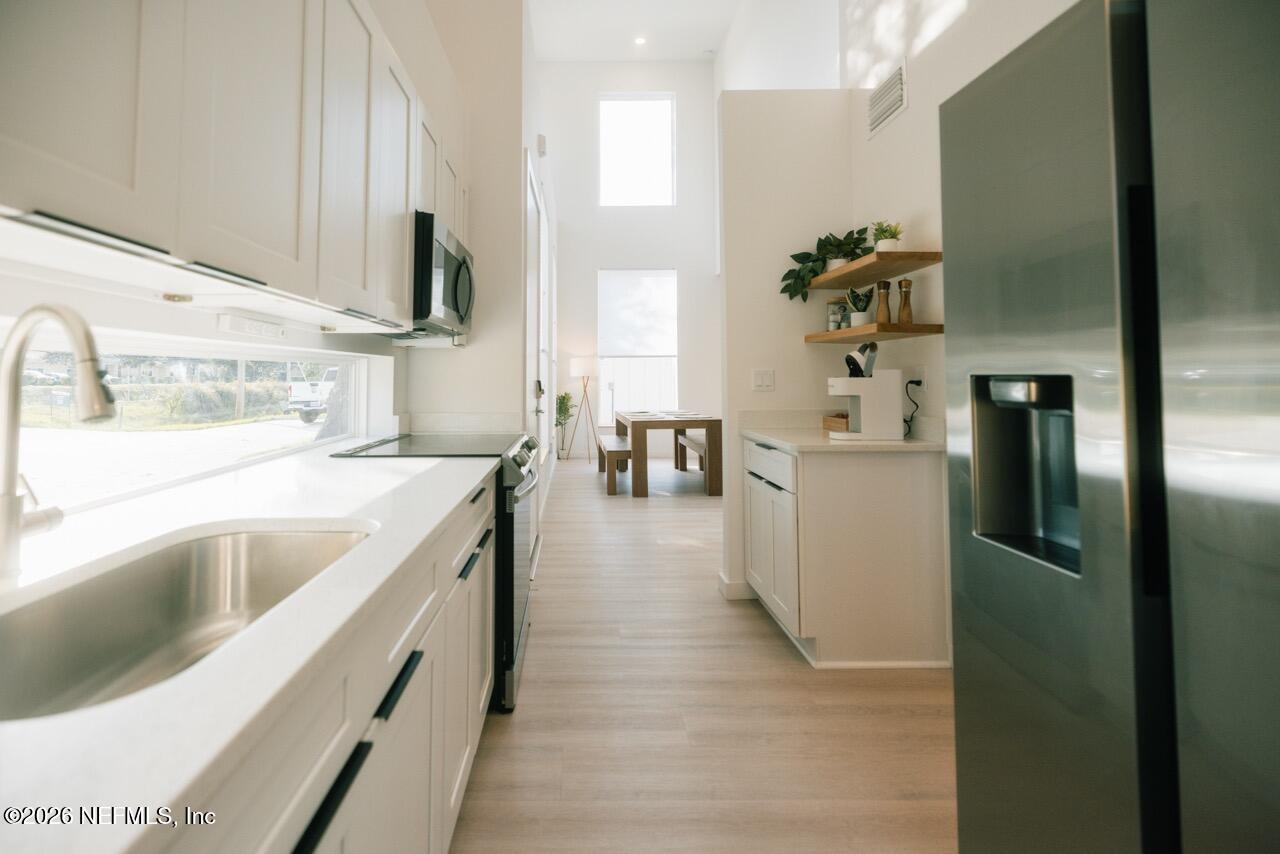 3318 Lewis Speedway St. Augustine, FL 32084 - Photo 7 of 23 a kitchen with a sink cabinets and refrigerator