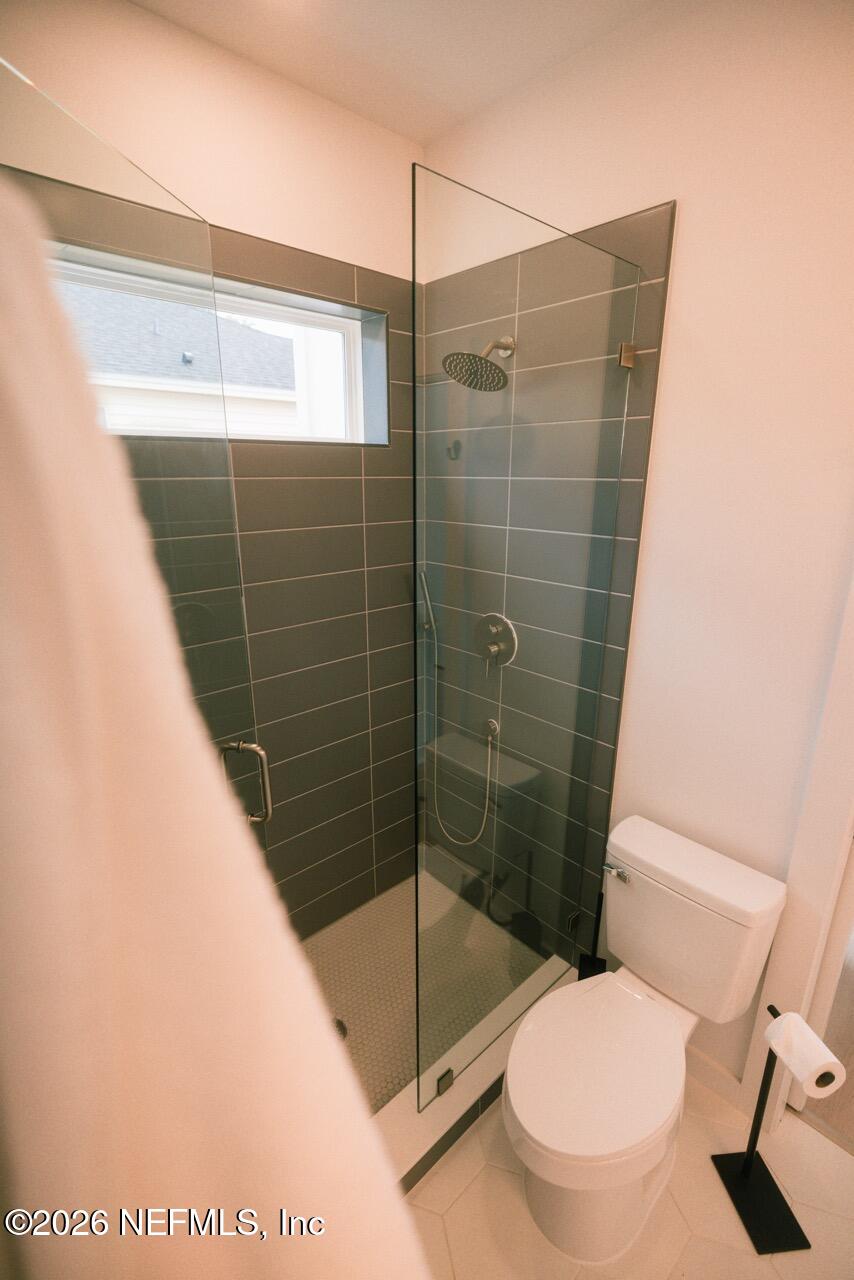 3318 Lewis Speedway St. Augustine, FL 32084 - Photo 8 of 23 a bathroom with a toilet and a shower