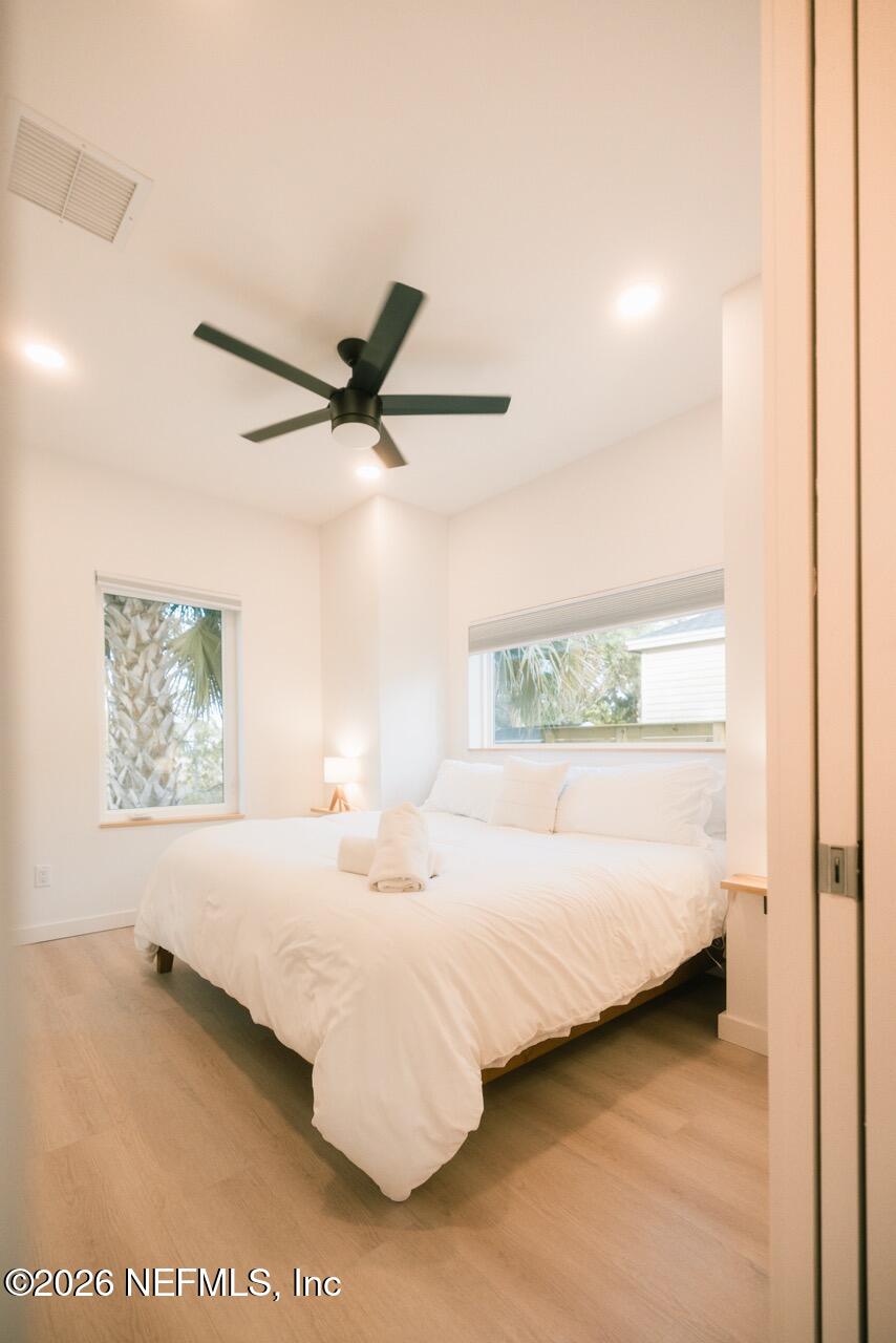 3318 Lewis Speedway St. Augustine, FL 32084 - Photo 10 of 23 a bedroom with a bed and a painting on the wall